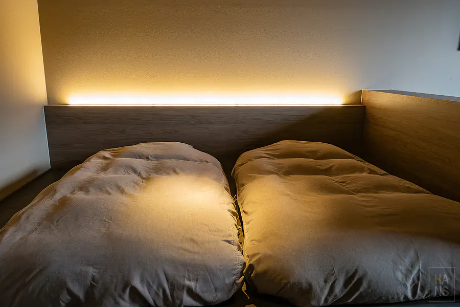 客房內舒適的低床架設計與厚實柔軟的寢具搭配柔和床頭照明