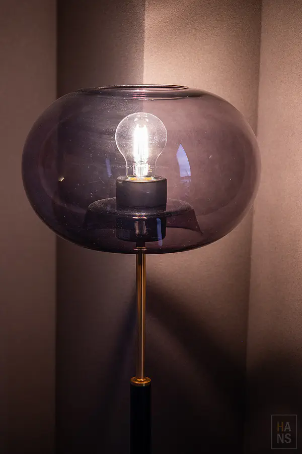 客房內極具質感的煙燻紫灰色玻璃桌燈散發溫暖迷人的藝術光芒